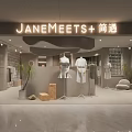 Modern Clothing Store Interior With Mannequins Clothes Racks And Green Plants