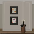 Black Framed Abstract Paintings Hanging On Light Colored Wall With Small Table Lamp 3d model