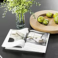 Vase With Green Flowers White Blooms Wooden Tray Fresh Limes Open Magazine On Black Tabletop