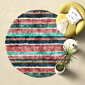 Colorful Striped Round Rug with Yellow Chair White Pillow and Plant in Cozy Living Space
