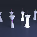 White Decorative Pillars With Small Flowers And Colored Ribbons On Dark Background