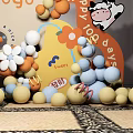Colorful Balls And Flower Decor With Cartoon Cow For Happy 102 Days Celebration