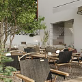 Garden Landscape Design Featuring Outdoor Courtyard Green Trees Wooden Tables Chairs White Walls and Awning