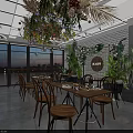 Elegant Plant Decorated Specialty Store Interior With Wooden Tables Chairs Hanging Plants And Pendant Lights