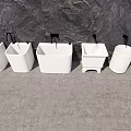 Multiple White Bathroom Sinks In Different Styles Against Stone Wall 3d model