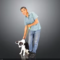 Cute black and white puppy being walked with yellow leash by man in gray background