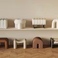Minimalist Modern Furniture Display With Decorative Objects And Stylish Stools On Herringbone Wooden Floor