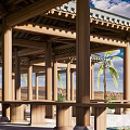 Traditional Open Wooden Pavilion Featuring Green Tiled Roof And Stone Surroundings