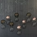 Modern Spherical Pendant Lights With Copper And Black Glass Balls Hanging On Gray Background