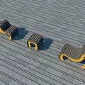 Three Modern Public Chairs With Wooden Seats And Yellow Metal Frames On Outdoor Wooden Floor