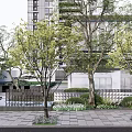 Modern Feature Wall Surrounded by Trees and Greenery with Paved Walkway and High Rise Buildings