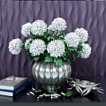 White Flowers In Silver Vase With Green Leaves And Decorative Books On Stylish Table