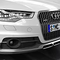 White Audi Avant Station Wagon In Indoor Garage With Tire Tracks On Floor
