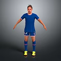 Man in Blue Soccer Jersey and Blue Shorts Standing on Gray Background with Yellow Shoes