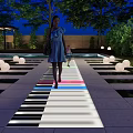 Park Landscape With Piano Keyboard Path Colorful Lights People Walking Round Lights And Pool Area