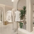 Modern Light Colored Clothing Store Interior With Hanging Racks Displayed Clothes And Plants