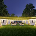 Garden Landscape At Night With White Tents String Lights And People Sitting On Grass