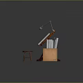 Wooden Drawing Desk And Stool With Blueprints Table Lamp Scrolls And Cardboard Box