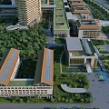 Aerial view of modern hospital building with greenery surrounding trees and multiple structures