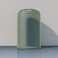 Light Green Glass Cylindrical Vase With Smooth Glossy Surface On Gray Background Wall