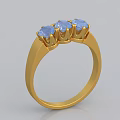 Elegant Gold Ring With Three Blue Gemstones In Crown Shaped Settings 3d model