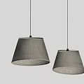 Two Modern Pleated Fabric Pendant Lights With Warm Glow On Gray Wall