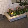 Outdoor Lights By Rectangular Flower Bed With Pink Flowers Green Plants And White Tiled Wall