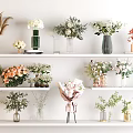 Decorative Ornament Arrangement With Various Vases Flower Bouquets And Green Plants On White Shelves