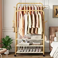 Golden Clothes Rack With Hanging Colorful Garments And Storage Shelves In Bedroom