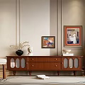 Brown Wooden TV Stand With Drawers Glass Doors And Decorative Items On Light Colored Wall
