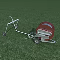 Mobile Agricultural Irrigation Equipment With Red Reel And Wheels On Green Field