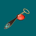 Gold Keychain Pendant With Red Circular Element And Black Peacock Feather Design