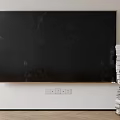 Black Wall Mounted Television Against White Wall with Stacked Books and Wooden Floor