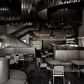 Modern Café Interior With Spiral Black Chandeliers Curved Seating Tables Chairs And Staircase