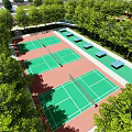 Beautiful Park Landscape Featuring Multiple Tennis Courts Green Surfaces Red Ground And Trees
