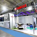 Yamaha Modern Exhibition Booth Featuring White Vehicle Blue Carpet And Purple Decorations