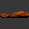 Four Fresh Red and Orange Textured Almonds on Dark Background