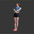 Woman Smiling While Holding Blue Items Wearing Black Shorts And Pink Sneakers On Gray Background