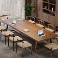 Wooden Conference Table With Laptops Documents And Chairs Near Window Plant