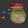 Silver Storage Jar With Open Red Lid And Colorful Small Round Pieces On Black Surface