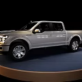 Shiny Silver Four Door Pickup Truck On Circular Display Platform With Black Background