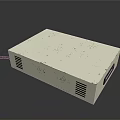 White Rectangular Electronic Device With Ventilation Grilles And Black Cable
