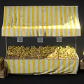 Fresh Bananas Display At Yellow And White Striped Fruit Stall With Wooden Crates