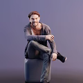 A Man Sitting On Gray Cube Wearing Gray Cardigan And Dark Pants With Beard