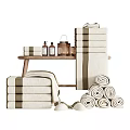 Cozy Bathroom Accessories Set With Soft Rolled And Stacked Towels Wooden Table Candles And Bottles