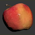 Fresh Red and Yellow Apple with White Spots and Glossy Surface on Black Background