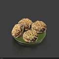 Four Delicious Nut Sprinkled Doughnuts Served on a Green Plate