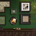 Green Wall With Multiple Frames And Dark Wooden Cabinet With Books Box Fruits And Plant