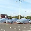 Luxury Sports Cars Parked In Urban Parking Lot With Street Lamps And Church Dome