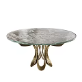 Round Glass Top Dining Table With Artistic Curved Metal Base Design